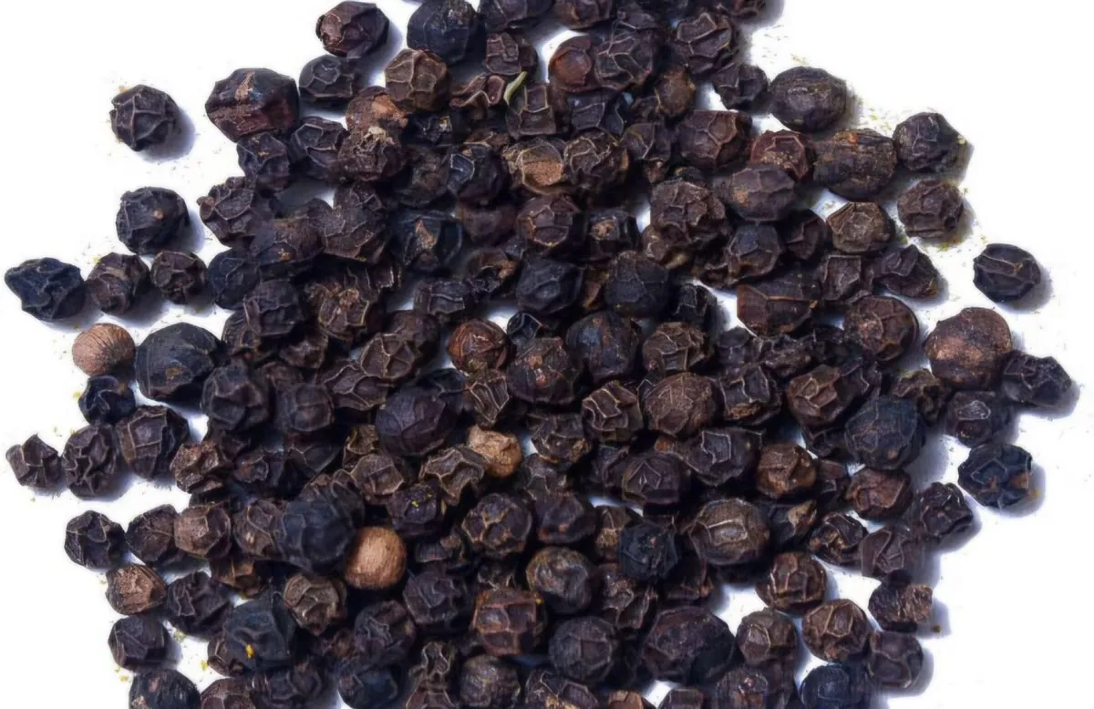 Whole dried black peppercorns, representative photograph